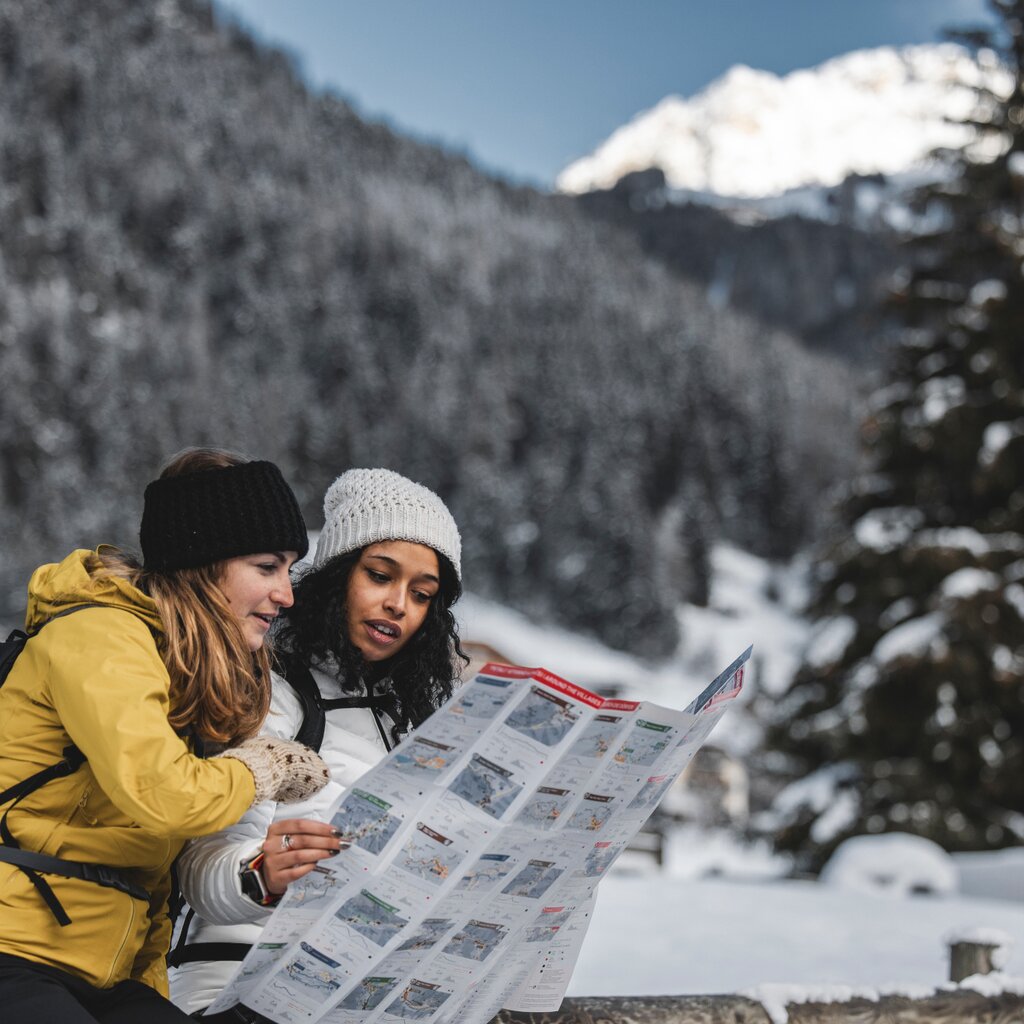 Due ragazze leggono la cartina delle passeggiate invernali in val di fassa | © Archivio Immagini ApT Val di Fassa - Federico Modica